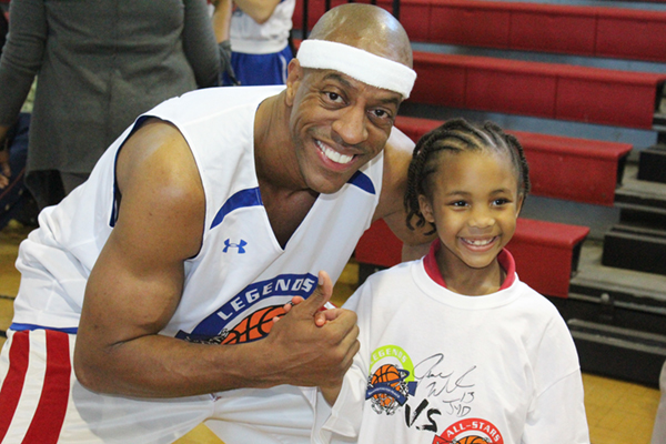 Jerome Williams and young basketball player posing and smiling for pictures.
