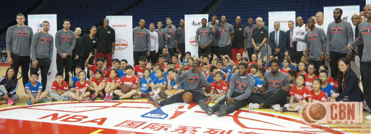 Group photo of NBA players with young participants.